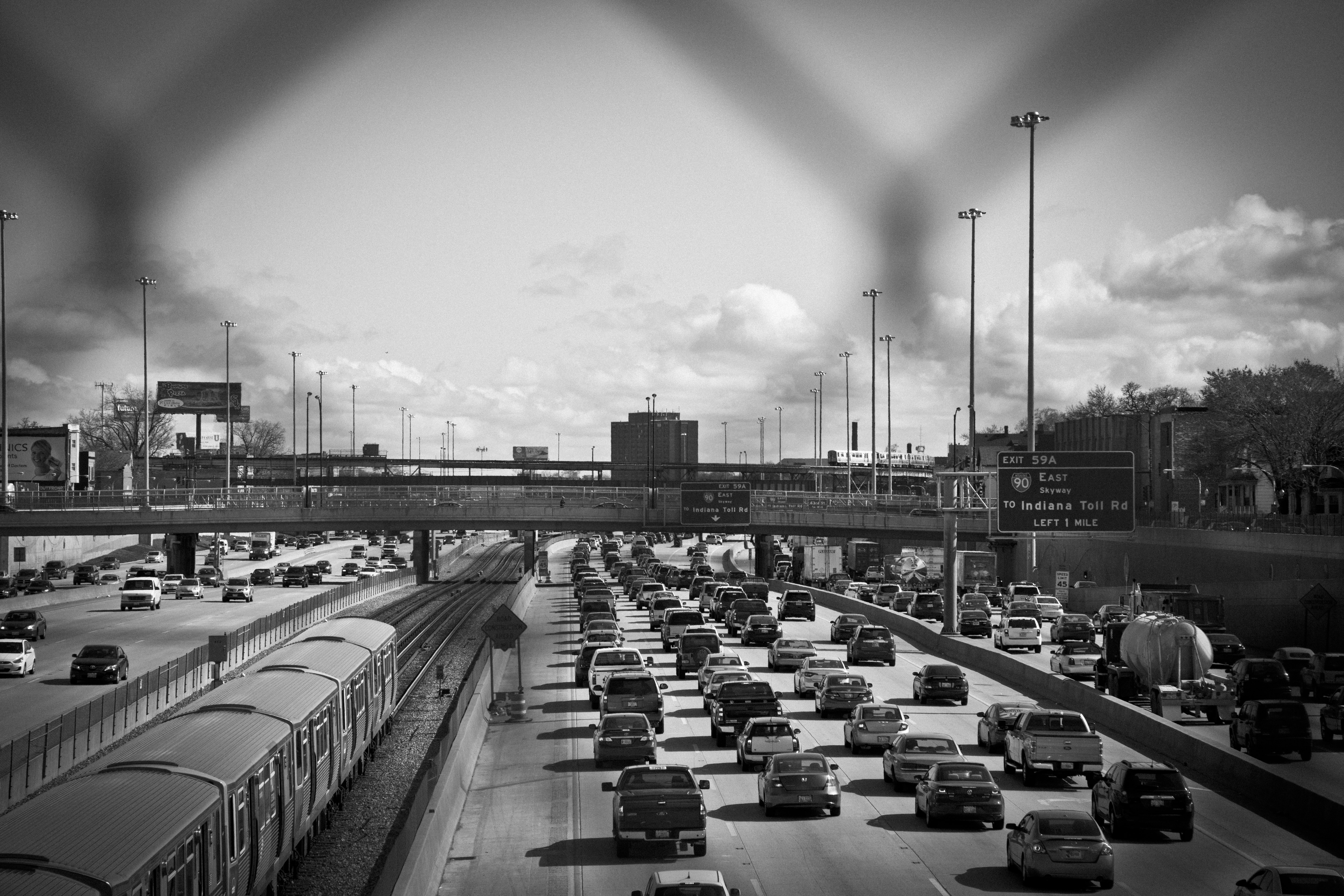 grayscale photo of cars on road